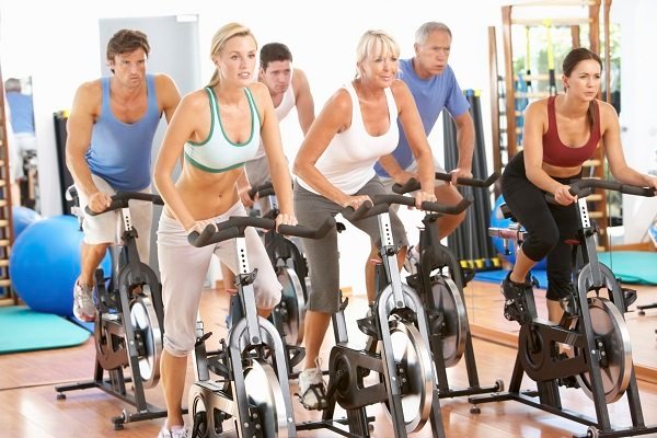 Group Of People In Spinning Class At Gym